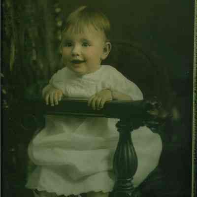 Child sitting on tufted cushion...