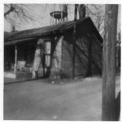 Log house with siding on E. Broadway