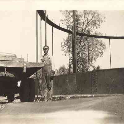 Man standing by wagon with gas tank