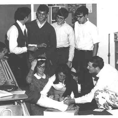 1991.016.004B: John Kemper and students from Shelbyville High School, signing a friend's leg cast