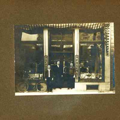 3 Unknown Men standing in front of a Schroeder Pharmacy