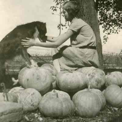 Dorothy Wasson Sitting on Pumpkins w/ Dog