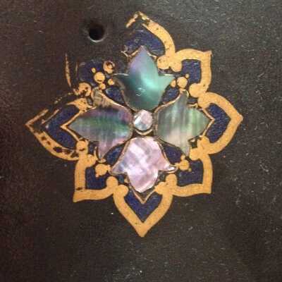 Detail of painted design and abalone shell inlay