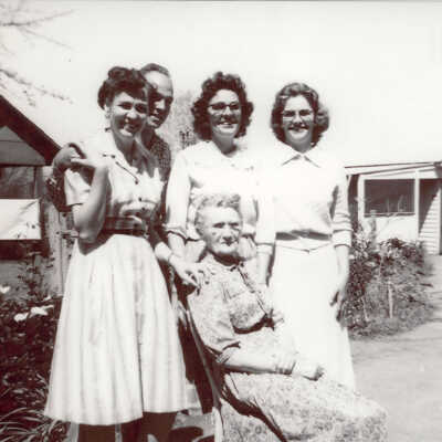 Left to Right: Betty Stevens, Tom Jr., Carolina, Adrian, Dorothy, and Julia Lass in the Front Row in Front of the Bird Cage, 1961