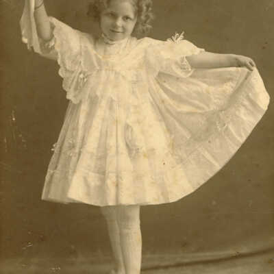Julia Lass, daughter of Fred and Julia Lass, holding the tambourine