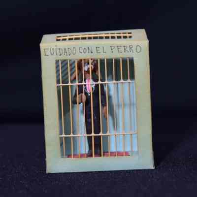 Clay dog figure. "Cuidado con El Perro"