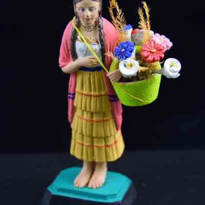 "Woman carrying flower basket"