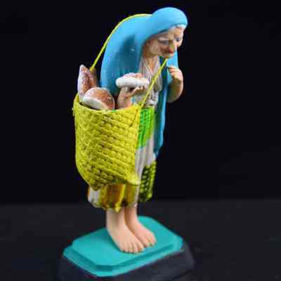 "Elderly woman with bread basket"