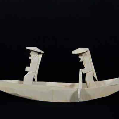 Boat with carved fisherman figure