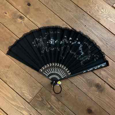 Black fan w/ white floral design