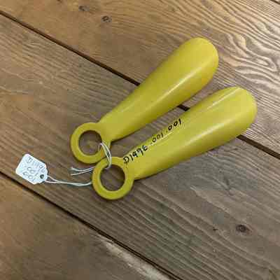 2 yellow shoe horns
