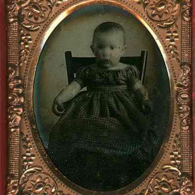 Baby in Checked Dress in High Chair