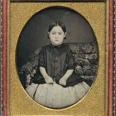 Little Girl in Saque on Sofa