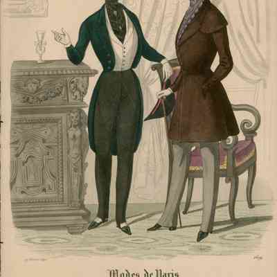 2 Men Conversing in Artistic Parlor, One in Opera Dress