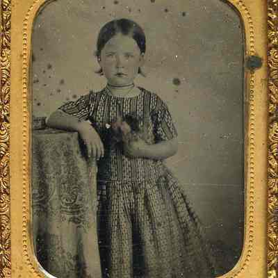Little Girl in Bold Print, Holding Bunch of Flowers