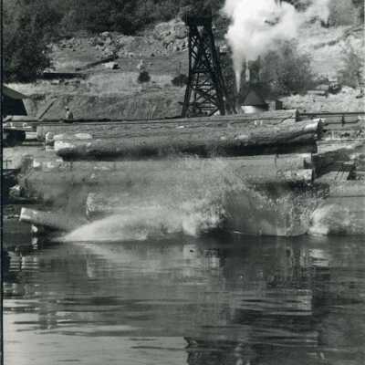 Logs rolling into mill pond