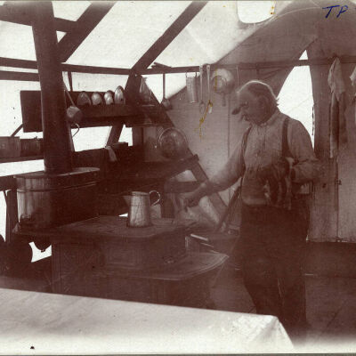 Unidentified man in tent with cookware