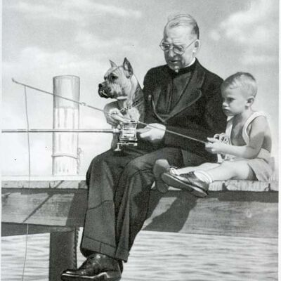 A Priest, small boy and dog