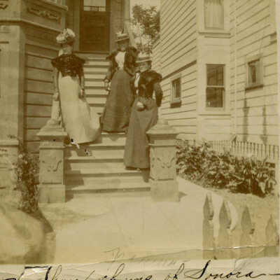 Three women on house steps