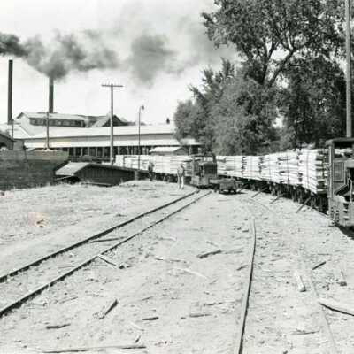 Two mule trains loaded with lumber