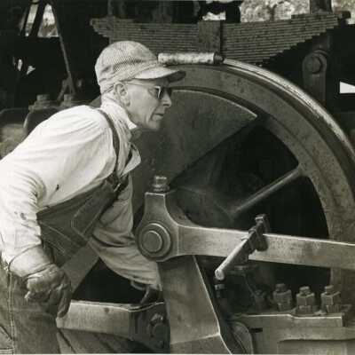 Sierra Railroad - man working on drive rods.
