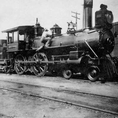 Sierra Railway locomotive, with worker polishing