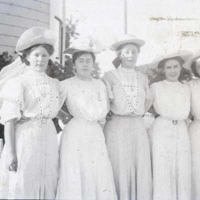 Five women standing in formal wear