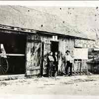 Sign Shop Exterior with Workers - Photograph