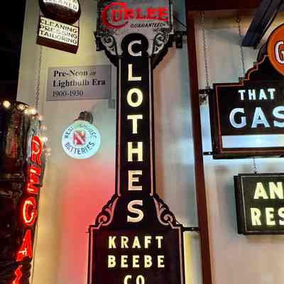 Curlee Clothes Opal Glass & Metal Sign