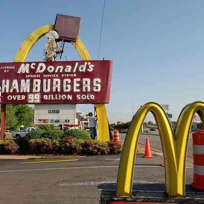 Chad Johson (white t)  with Empire Crane of Hsv begin taking down the entrance sign in front of the McDonald's on Memorial Pkwy access road near Drake Ave on Tues.  According to Steve Johnson, Owner/operator of Johnson Partners, Inc of Hsv the sign will be taken to the American Sign Museum in  Cincinnati, Ohio.  It was installed in Sept 1963. It will be replaced with a double arch sign similar to the exit one on the right foreground.  dieter undefined