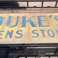          Close up of the lettering for 'Duke's Men Store'
   