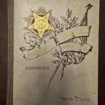 The book cover titled "Marching Through Georgia" features elaborate illustrations and golden accents.