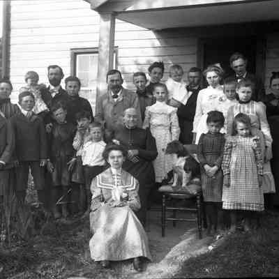 group of 24 people front of house