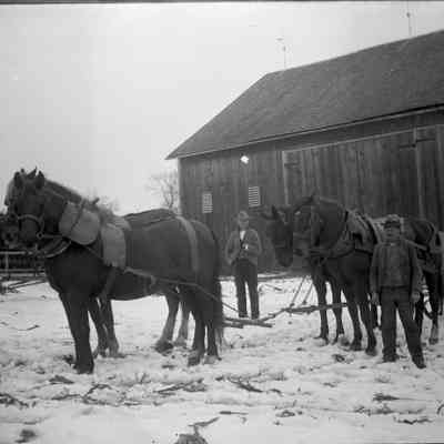 4 horses & wagon, 2 men, building