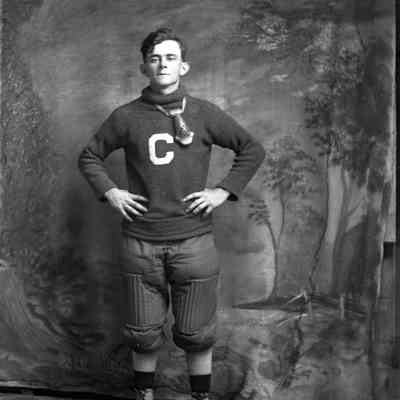 man in baseball uniform/ C on shirt