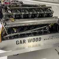          The image shows a complex Gar Wood Liberty marine engine, featuring multiple cylinders and intricate metal components.
   