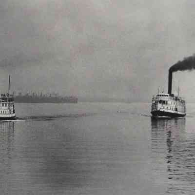 Oblique angle, long shot. Steamer Potomac on left and Calvert on right racing out of Baltimore.