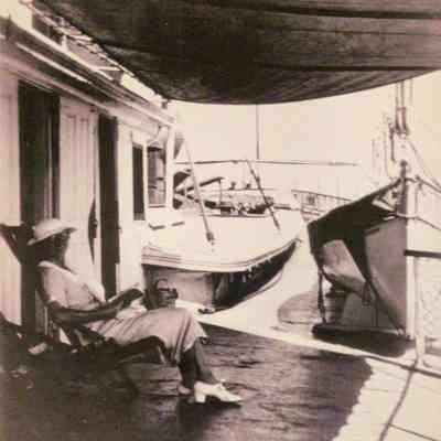 Oblique shot looking aft of the port side of the pilothouse with passenger seated on the hurricane deck. .