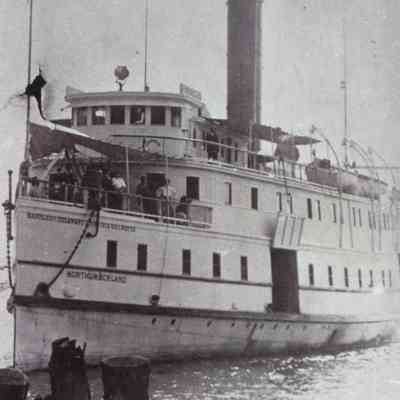 Oblique angle, closeup shot of port bow arriving at a wharf.