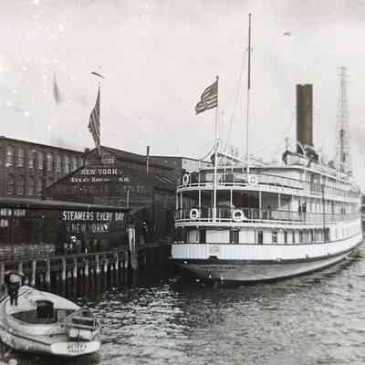 Oblique angle, mid-distance shot of stern and starboard side in New York Harbor.