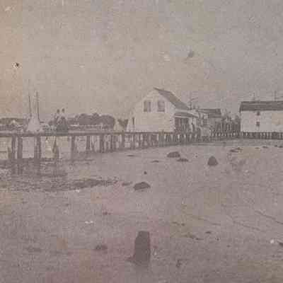 Weems Wharf area early in the 20th century before the area to the left was filled in with dirt and oyster shells.: Photograph from the Rappahannock Record in 1972.