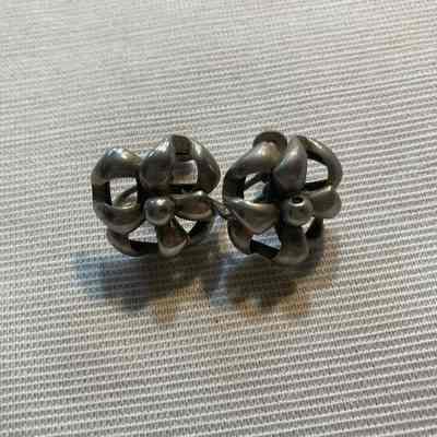 Pair of silver toned flower shaped earrings