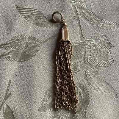 Gold colored metal tassel