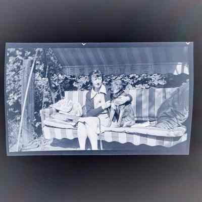 Negative of Emma Cohen Bray and a large dog
