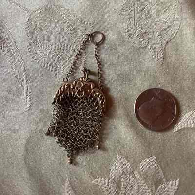 Small Metal, mesh coin purse with Kennedy half dollar inside