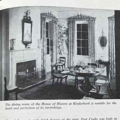 Representative page. Upper: inside of house. External: outside of house: Upper: Picture of dining room with windows, heavy drapes, wood table with tea set on platter. Fireplace with grate, ornate mirror above the fireplace.
Lower: Outside of house. Large house with 6 windows on second floor with white shutters (open). Trees in front and side of house.