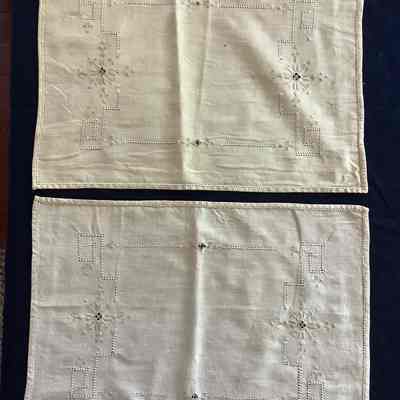 Two decorative hemmed textiles
