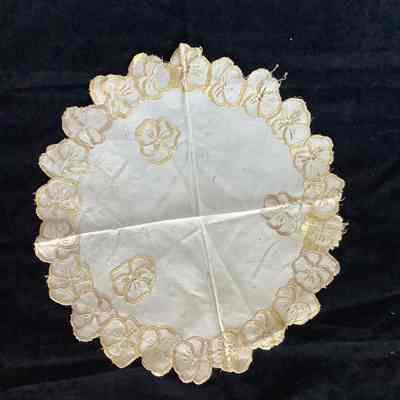 Round doily embroidered with pansy flowers