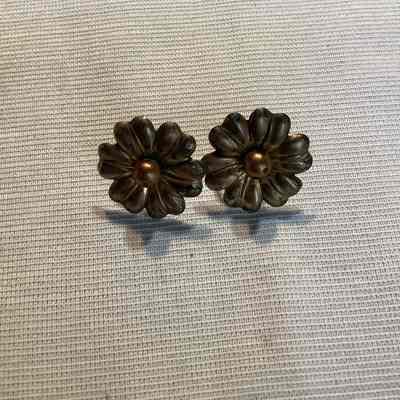 Pair of silver and bronze toned metal flower, screw back earrings.