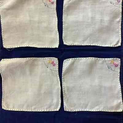 Four flower embroidered linens